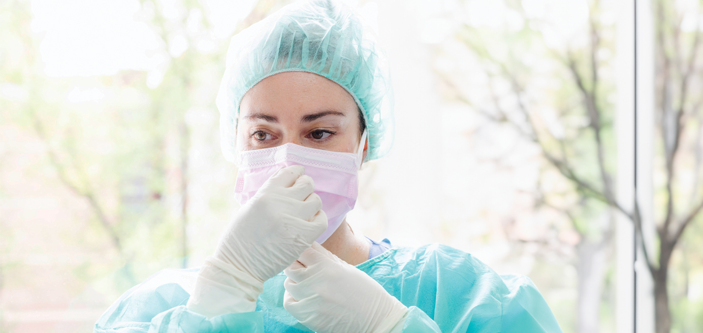 Picture of nurse in scrubs with a mask