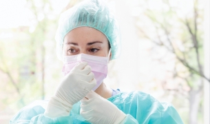 Picture of nurse in scrubs with a mask